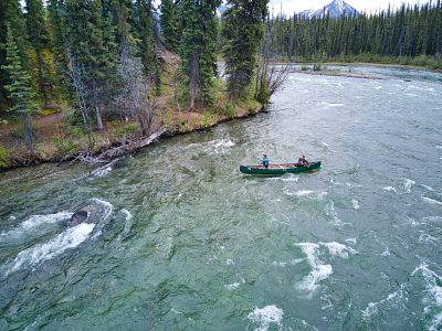 Two canoers tackling the Jaws of Death rapid section as seen from drone